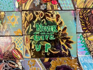 mosaic saying never give up